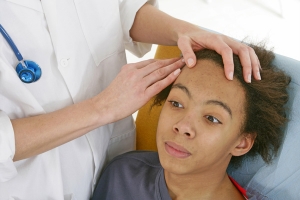 Woman being examined in dermatology clinic
